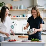 woman in white button up shirt holding white ceramic plate