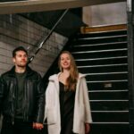 positive couple going downstairs in underground passage